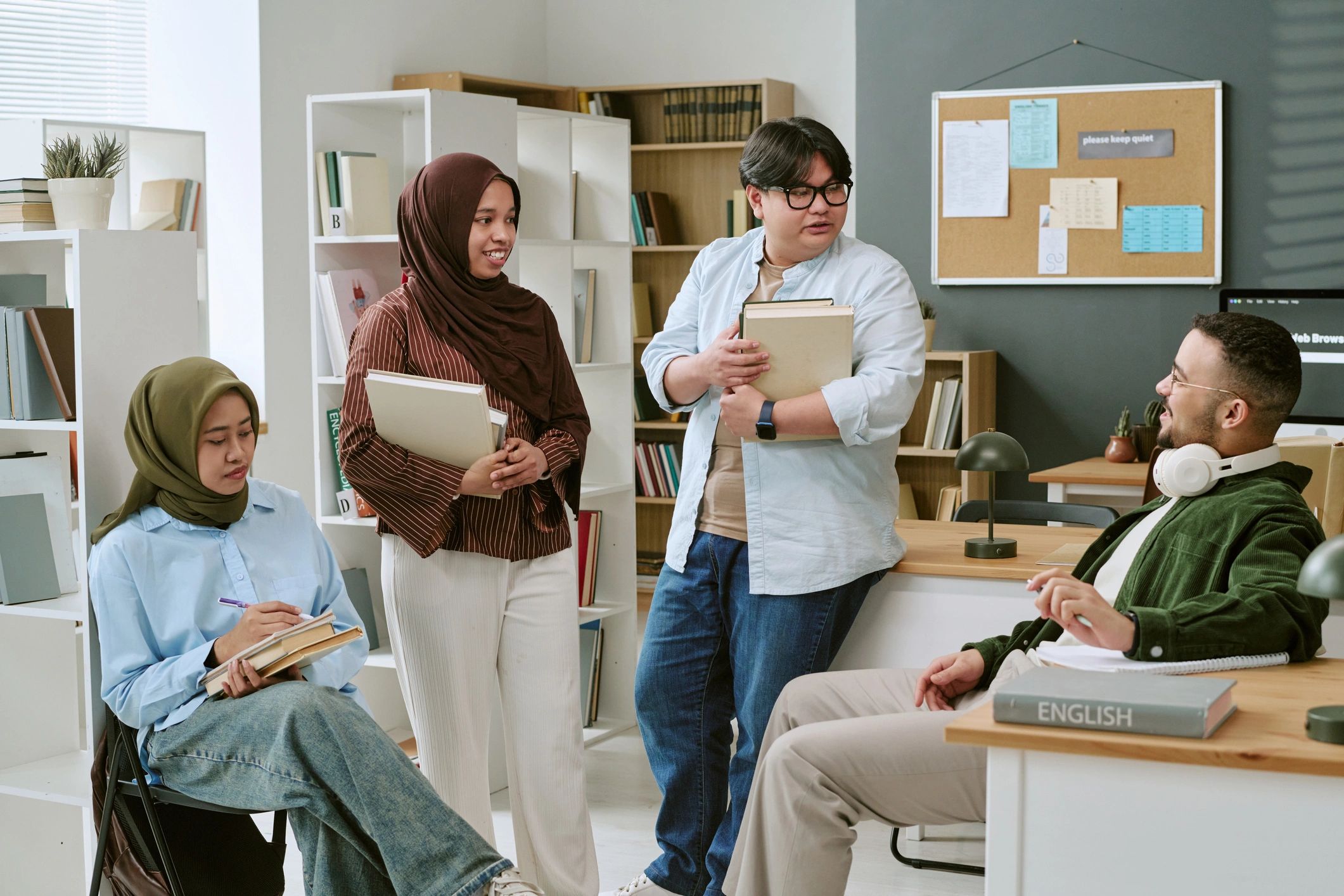 College students discussing coursework in a classroom