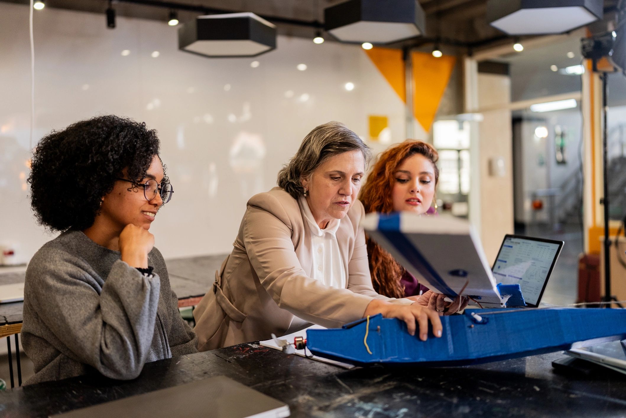 Faculty member guiding students in a university laboratory