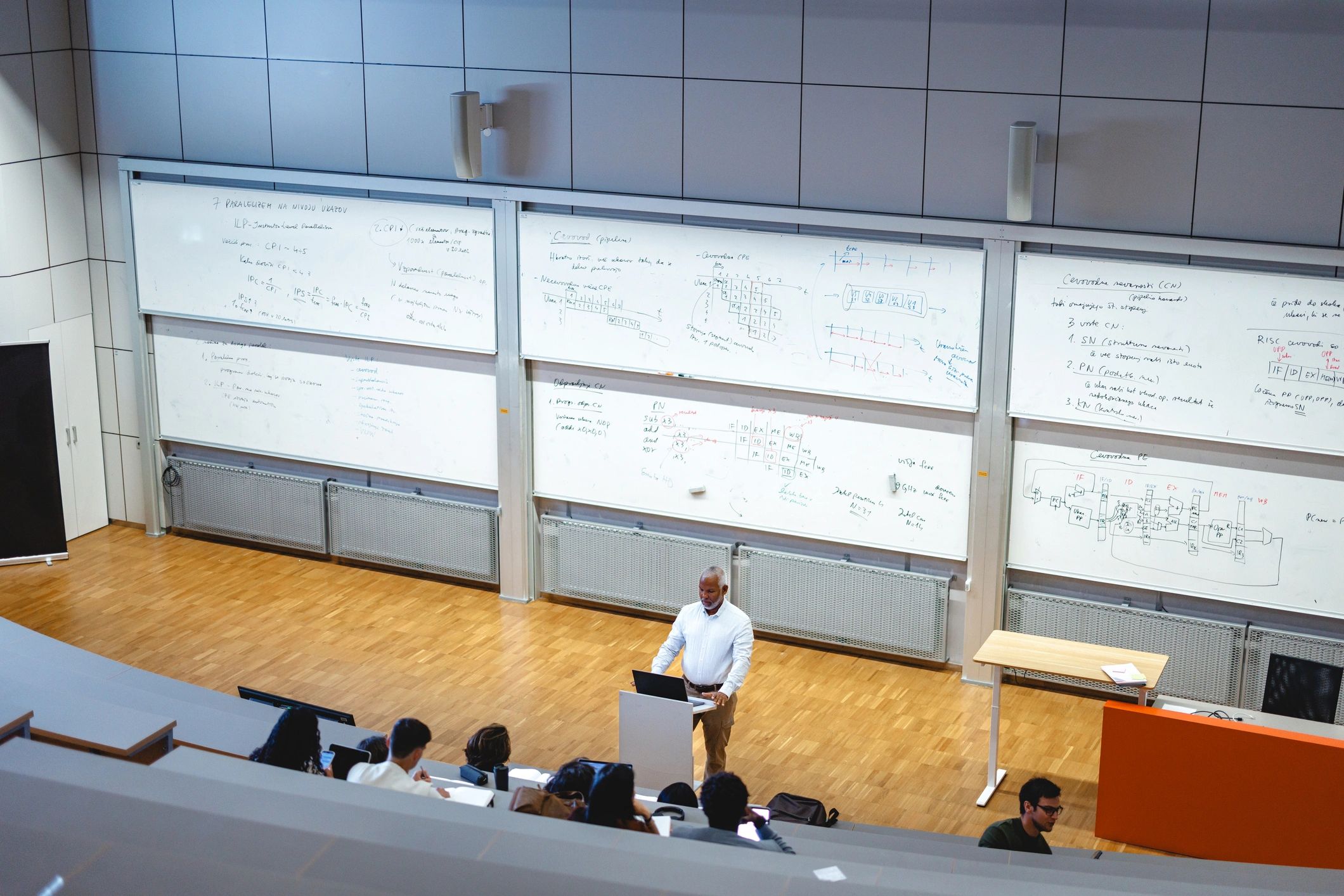 Professor addressing students in a university lecture hall